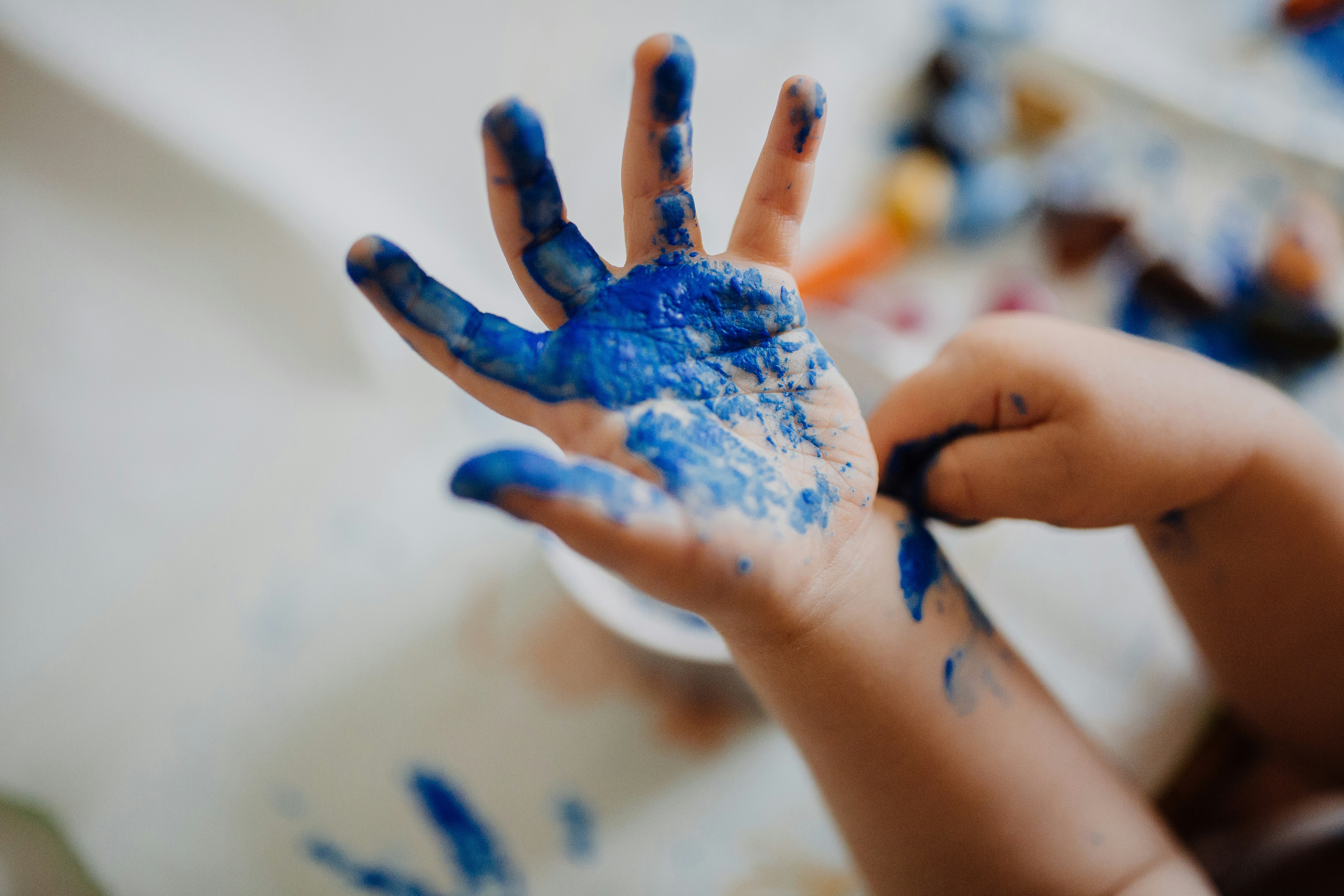 Child painting their hand