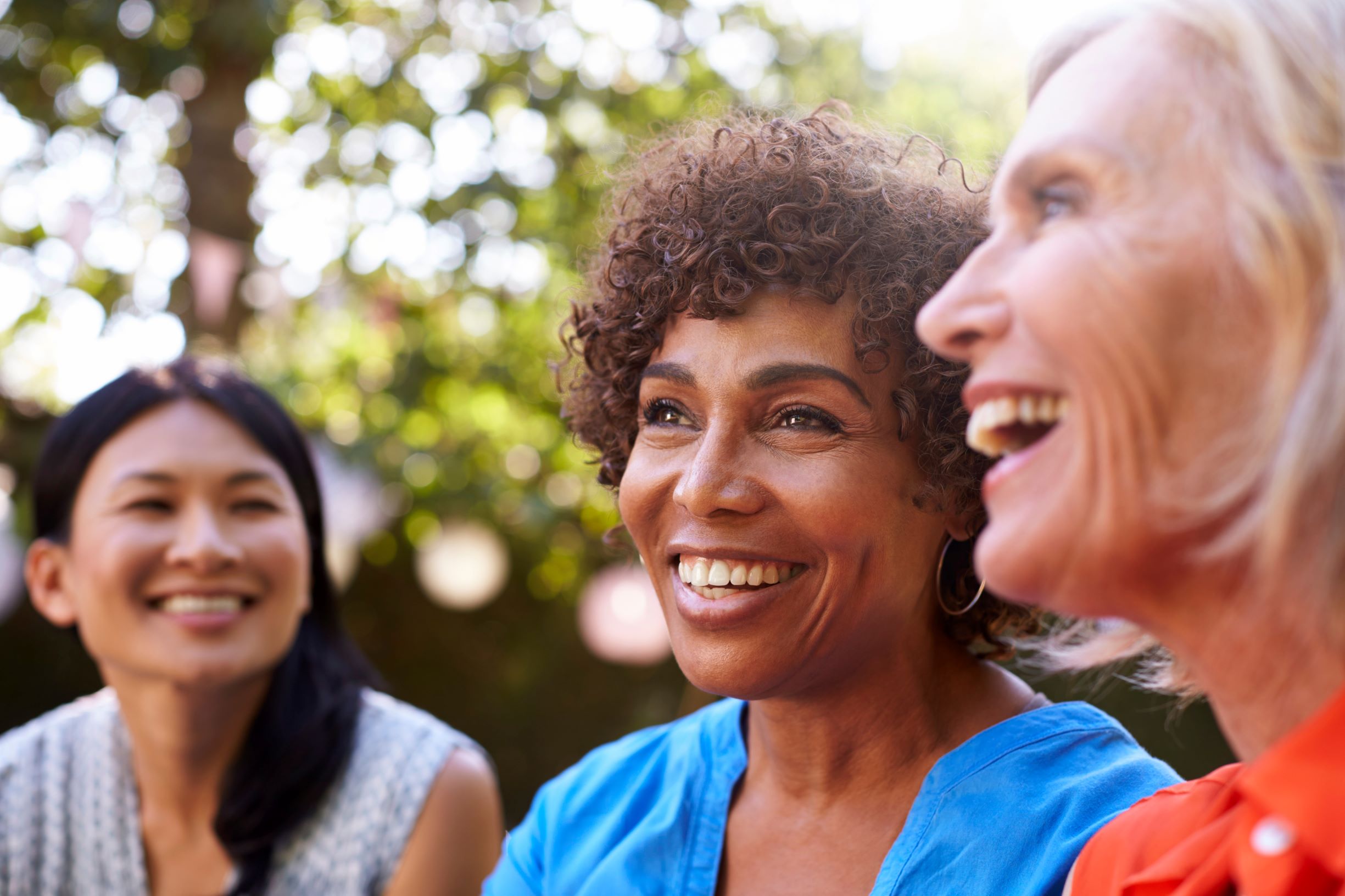 Three ladies chatting and laughing outside