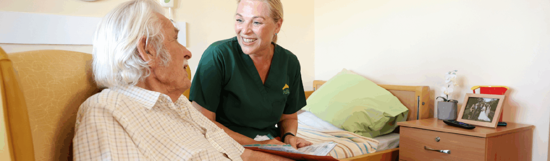 Male care home resident talking to carer